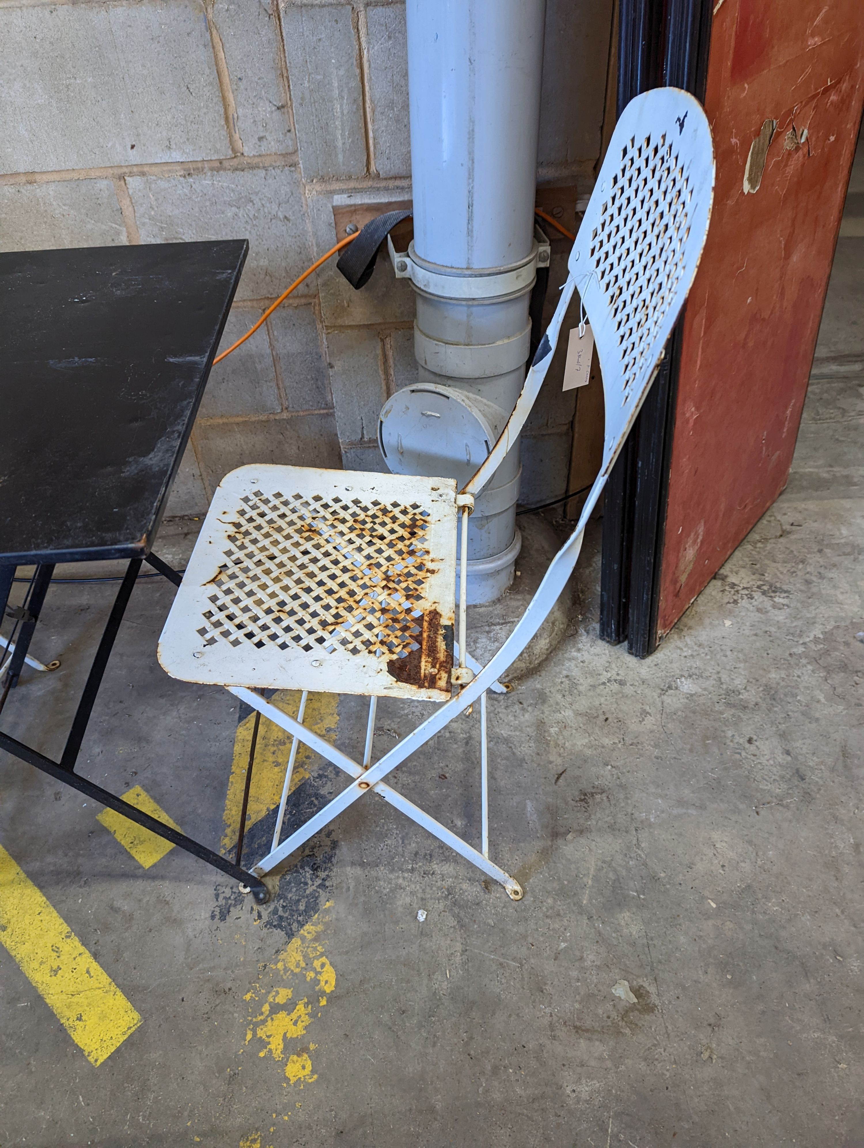 A square metal folding bistro table, width 60cm, height 71cm, together with two metal chairs